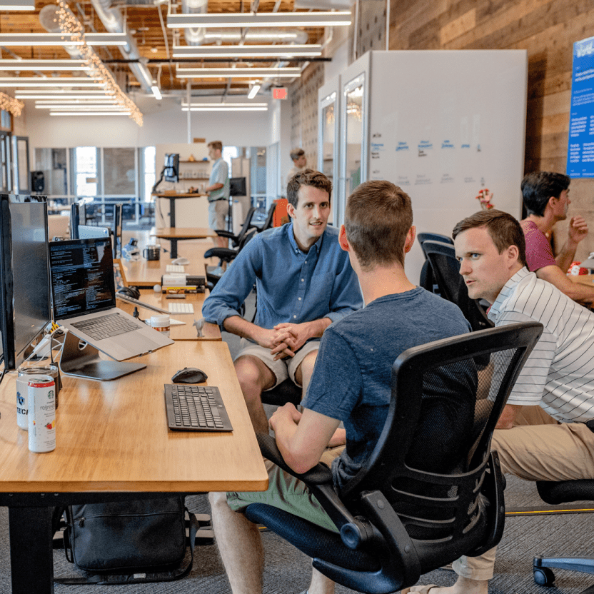 Agency developers collaborating in open office setting